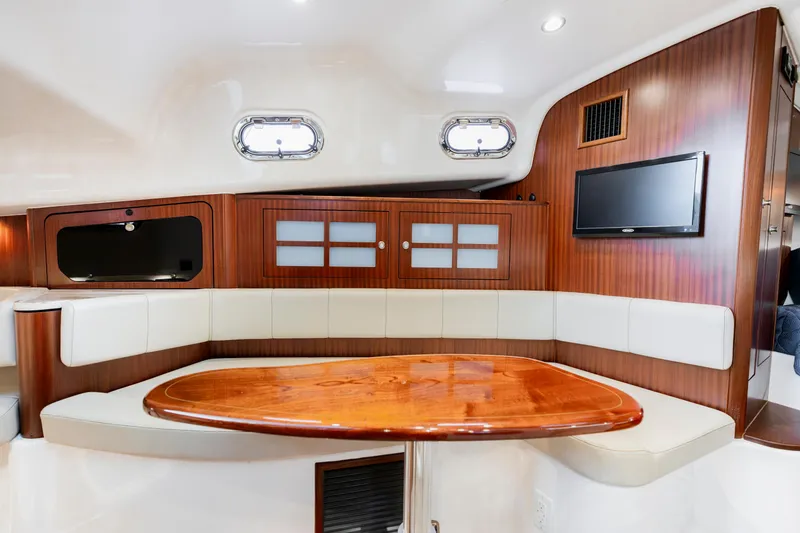 Slide: The Image of Luxurious interior of 2018 Pursuit OS 385 Offshore yacht with wood accents and seating area. - 31