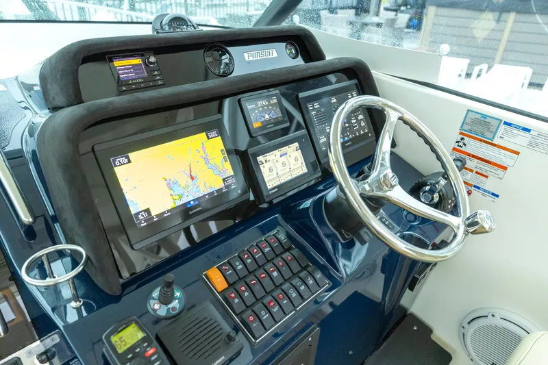 Slide: The Image of Helm of 2018 Pursuit OS 385 Offshore boat with navigation screens and controls. - 37