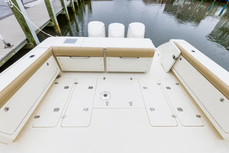Slide: The Image of 2018 Pursuit OS 385 Offshore boat deck with seating and storage compartments. - 4