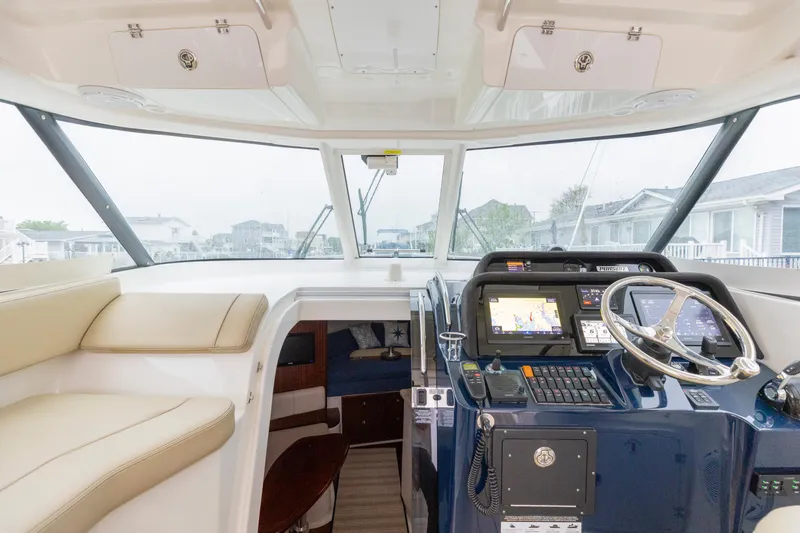 Slide: The Image of Interior view of 2018 Pursuit OS 385 Offshore boat cockpit with navigation equipment. - 44