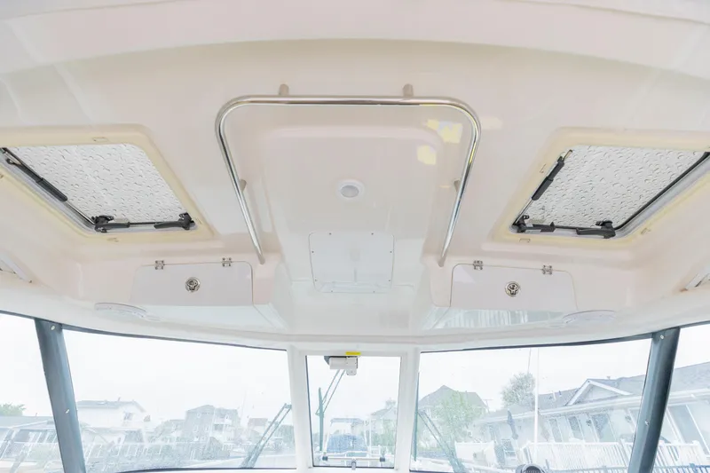 Slide: The Image of 2018 Pursuit OS 385 Offshore boat interior ceiling with hatches and storage compartments. - 45