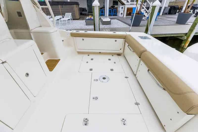 Slide: The Image of 2018 Pursuit OS 385 Offshore boat deck with seating and storage compartments. - 7