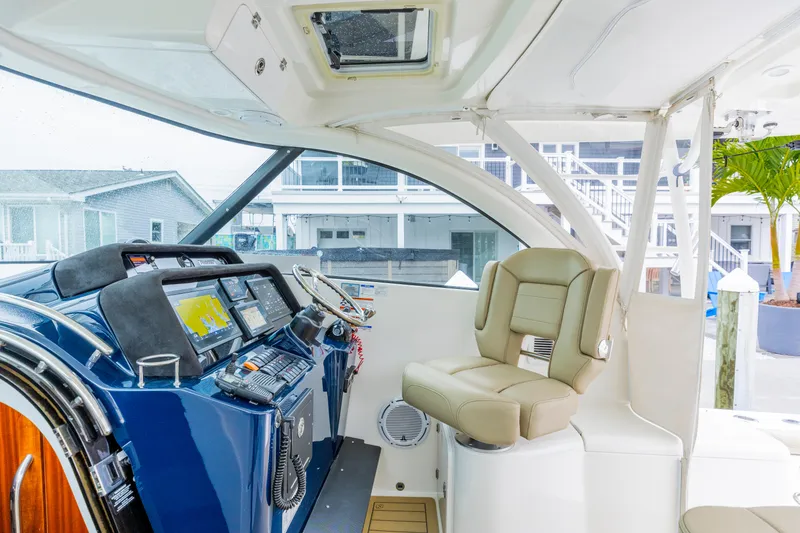 Slide: The Image of 2018 Pursuit OS 385 Offshore helm with advanced navigation systems and comfortable seating. - 9
