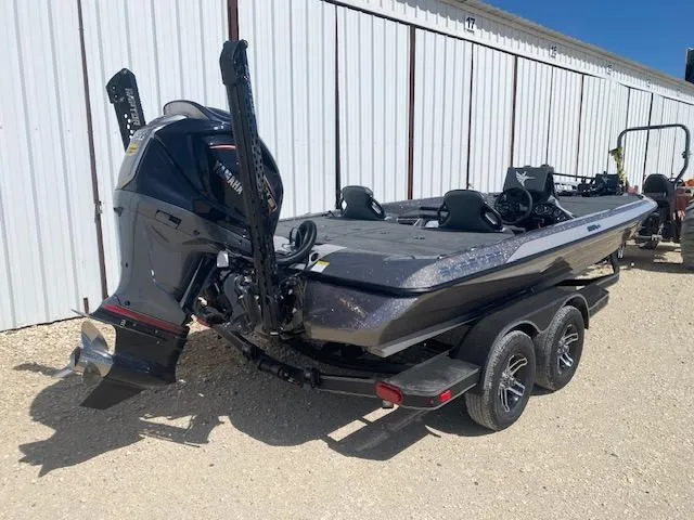 Slide: The Image of 2025 Skeeter ZXR21 boat with Yamaha engine, parked on a trailer near a white building. - 5