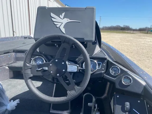 Slide: The Image of 2025 Skeeter ZXR21 boat dashboard with steering wheel and control panel. - 6