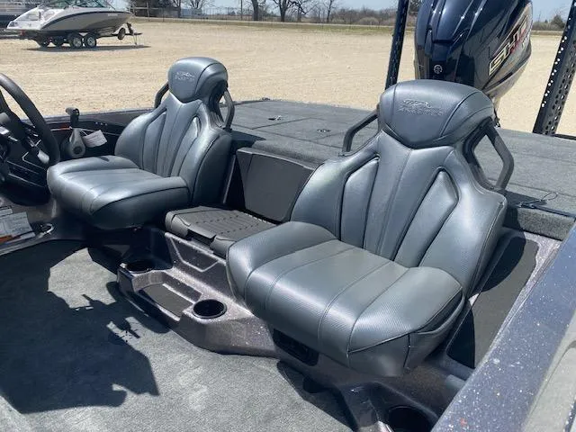 Slide: The Image of 2025 Skeeter ZXR21 boat interior with two gray seats and steering wheel. - 7