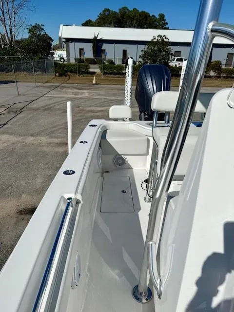 Slide: The Image of 2024 Contender 24 Sport boat, sleek design, outdoor setting, modern features, white finish. - 10
