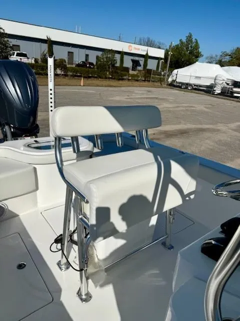 Slide: The Image of 2024 Contender 24 Sport boat interior with white seating and chrome accents. - 11