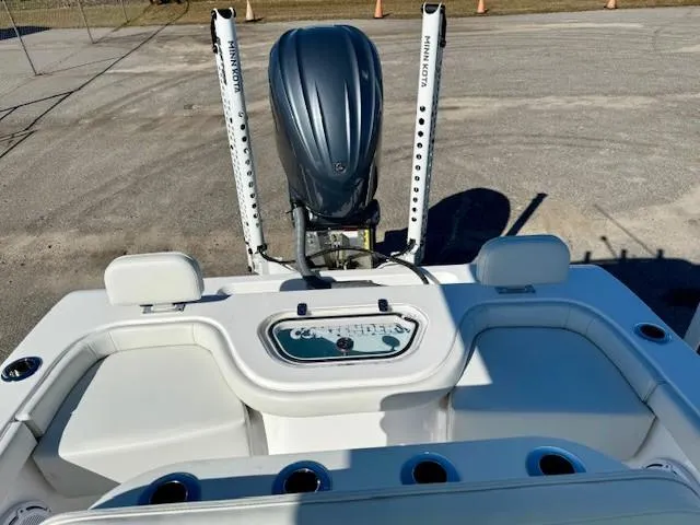 Slide: The Image of 2024 Contender 24 Sport boat with outboard motor and seating area. - 12