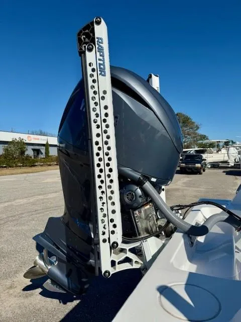Slide: The Image of 2024 Contender 24 Sport boat engine with Raptor mount in a sunny outdoor setting. - 18