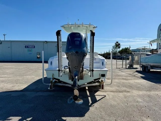 Slide: The Image of 2024 Contender 24 Sport boat with Yamaha engine, parked outdoors under clear blue sky. - 3