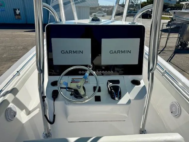 Slide: The Image of 2024 Contender 24 Sport boat dashboard with dual Garmin displays and steering wheel. - 6