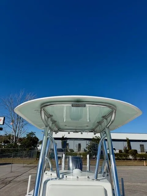 Slide: The Image of 2024 Contender 24 Sport boat with T-top against clear blue sky. - 9