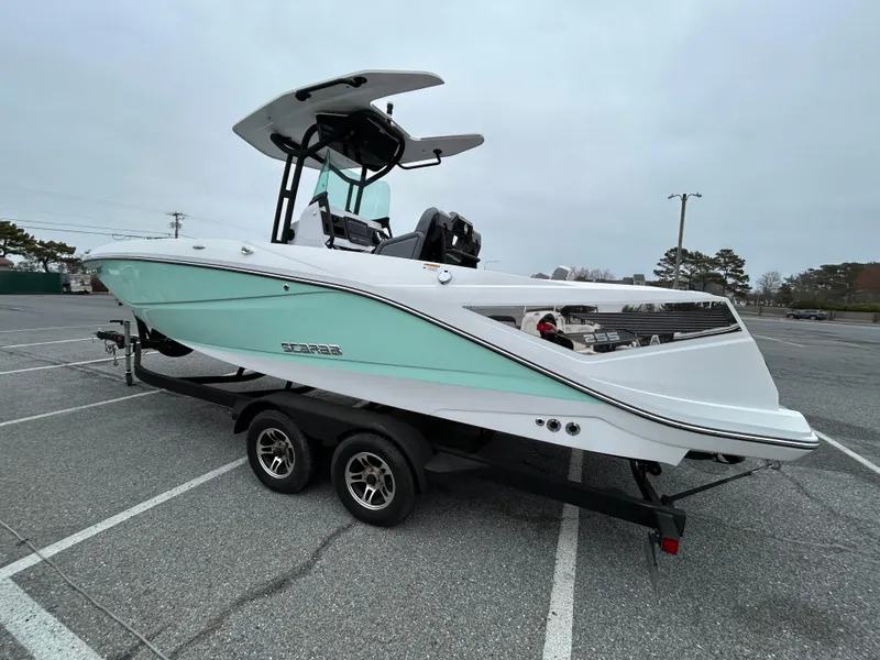 Slide: The Image of 2020 Scarab 255 Open ID boat on trailer in parking lot, side view. - 2