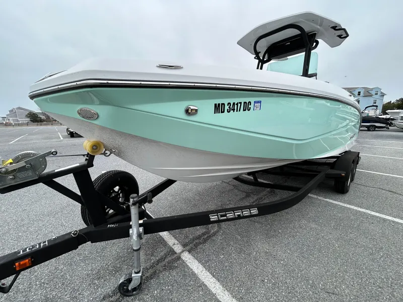 Slide: The Image of 2020 Scarab 255 Open ID boat on trailer in parking lot. - 3