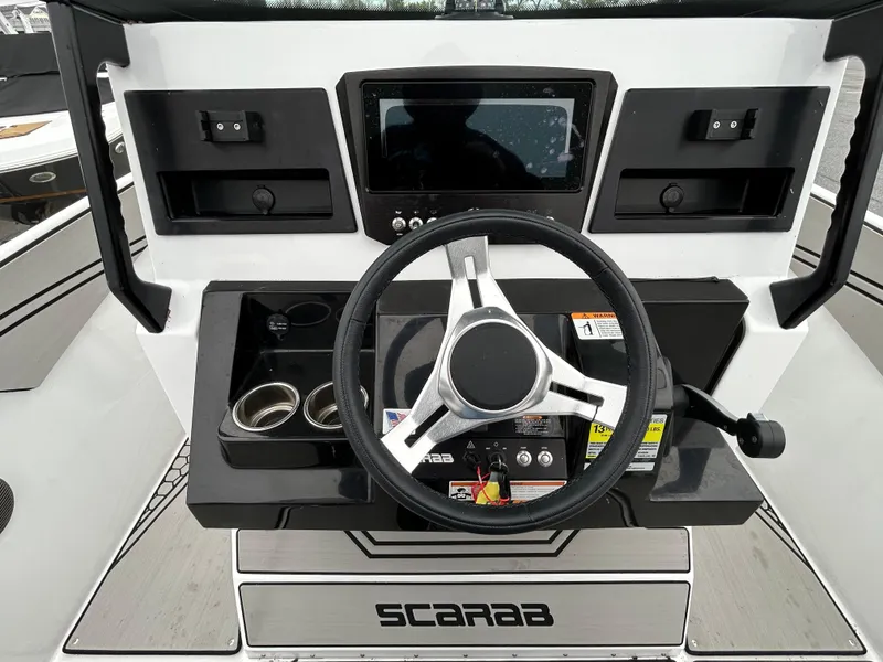 Slide: The Image of 2020 Scarab 255 Open ID boat dashboard with steering wheel and control panel. - 5