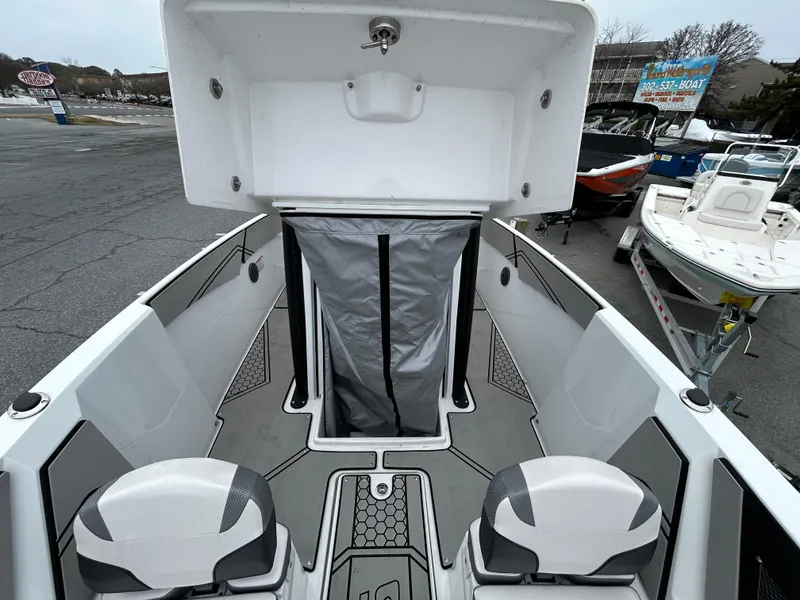 Slide: The Image of 2020 Scarab 255 Open ID boat interior with seating and storage compartment. - 7