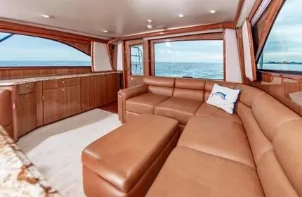 Slide: The Image of Luxurious interior of a 2006 Viking 48 yacht with ocean view and leather seating. - 14