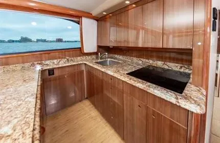 Slide: The Image of Luxurious kitchen interior of 2006 Viking 48 yacht with granite countertops and ocean view. - 19