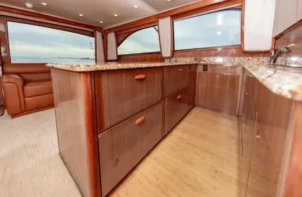 Slide: The Image of Luxurious interior of a 2006 Viking 48 yacht with wooden cabinetry and granite countertops. - 20