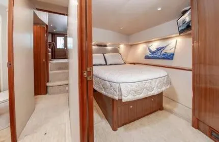 Slide: The Image of Luxurious bedroom interior of a 2006 Viking 48 yacht with elegant wood finishes. - 21