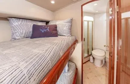 Slide: The Image of Bunk beds and bathroom in 2006 Viking 48 yacht interior. - 29