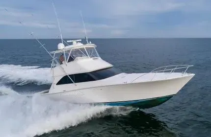 Slide: The Image of 2006 Viking 48 yacht cruising on open sea under clear sky. - 3