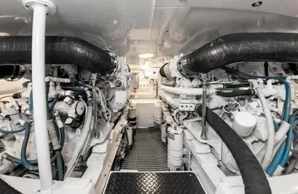 Slide: The Image of Engine room of a 2006 Viking 48 yacht, showcasing dual engines and mechanical components. - 32