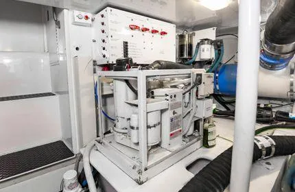 Slide: The Image of Engine room of 2006 Viking 48 yacht, featuring mechanical equipment and control panel. - 34