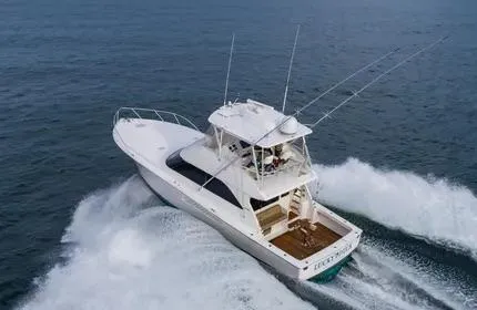 Slide: The Image of 2006 Viking 48 yacht cruising on open water, showcasing sleek design and powerful performance. - 4
