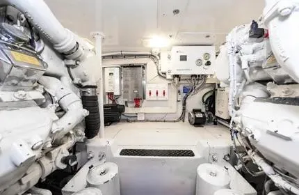 Slide: The Image of Engine room of 2006 Viking 48 yacht, showcasing machinery and control panels. - 41
