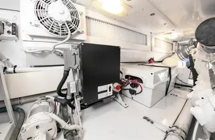 Slide: The Image of Engine room of 2006 Viking 48 yacht, featuring mechanical components and ventilation system. - 42