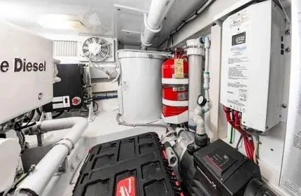 Slide: The Image of Engine room of 2006 Viking 48 yacht with diesel components and safety equipment. - 44