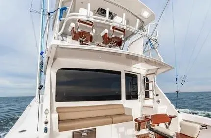 Slide: The Image of 2006 Viking 48 yacht with spacious deck and seating, cruising on open water. - 9