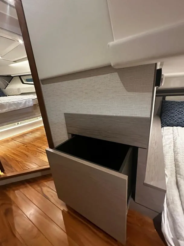 Slide: The Image of Interior of 2023 Tiara Yachts 43 LE, featuring a sleek wooden drawer and modern design. - 11