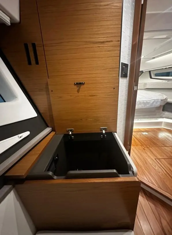 Slide: The Image of 2023 Tiara Yachts 43 LE interior with wooden cabinetry and open storage compartment. - 12