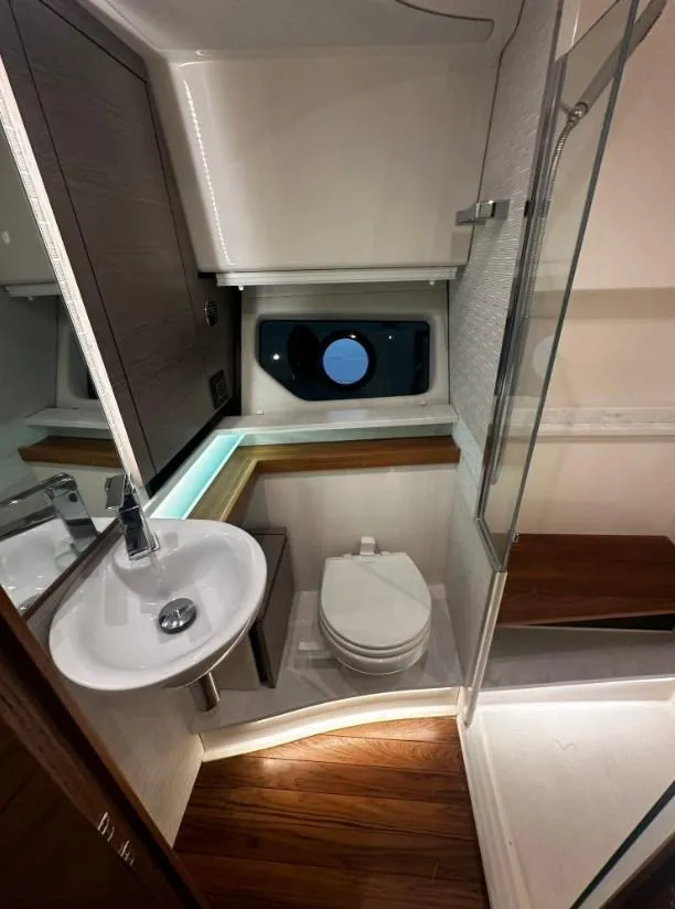 Slide: The Image of 2023 Tiara Yachts 43 LE bathroom with modern fixtures and wooden flooring. - 14