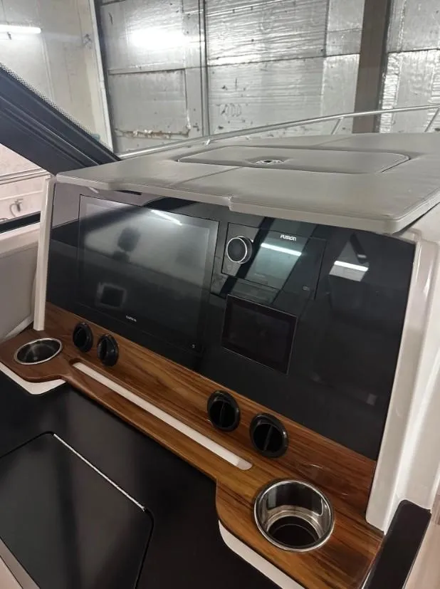 Slide: The Image of 2023 Tiara Yachts 43 LE dashboard with modern controls and wood accents. - 18