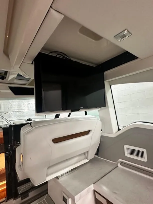 Slide: The Image of 2023 Tiara Yachts 43 LE interior with modern TV setup and sleek design. - 22