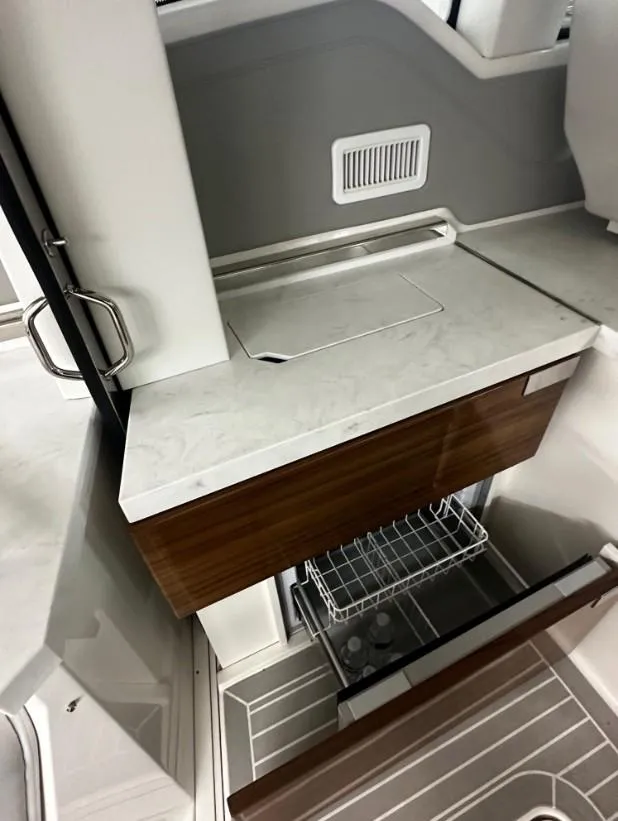 Slide: The Image of 2023 Tiara Yachts 43 LE interior with modern kitchenette and storage. - 24