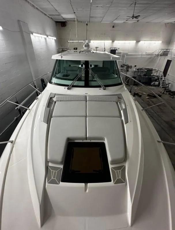 Slide: The Image of 2023 Tiara Yachts 43 LE in indoor storage, showcasing sleek design and spacious deck. - 27