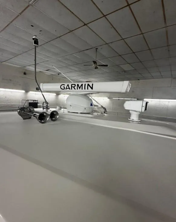 Slide: The Image of 2023 Tiara Yachts 43 LE with Garmin radar equipment in a modern indoor setting. - 28