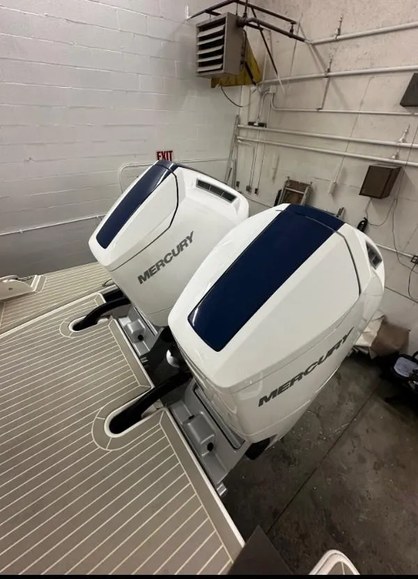 Slide: The Image of 2023 Tiara Yachts 43 LE with dual Mercury outboard engines in a garage setting. - 3