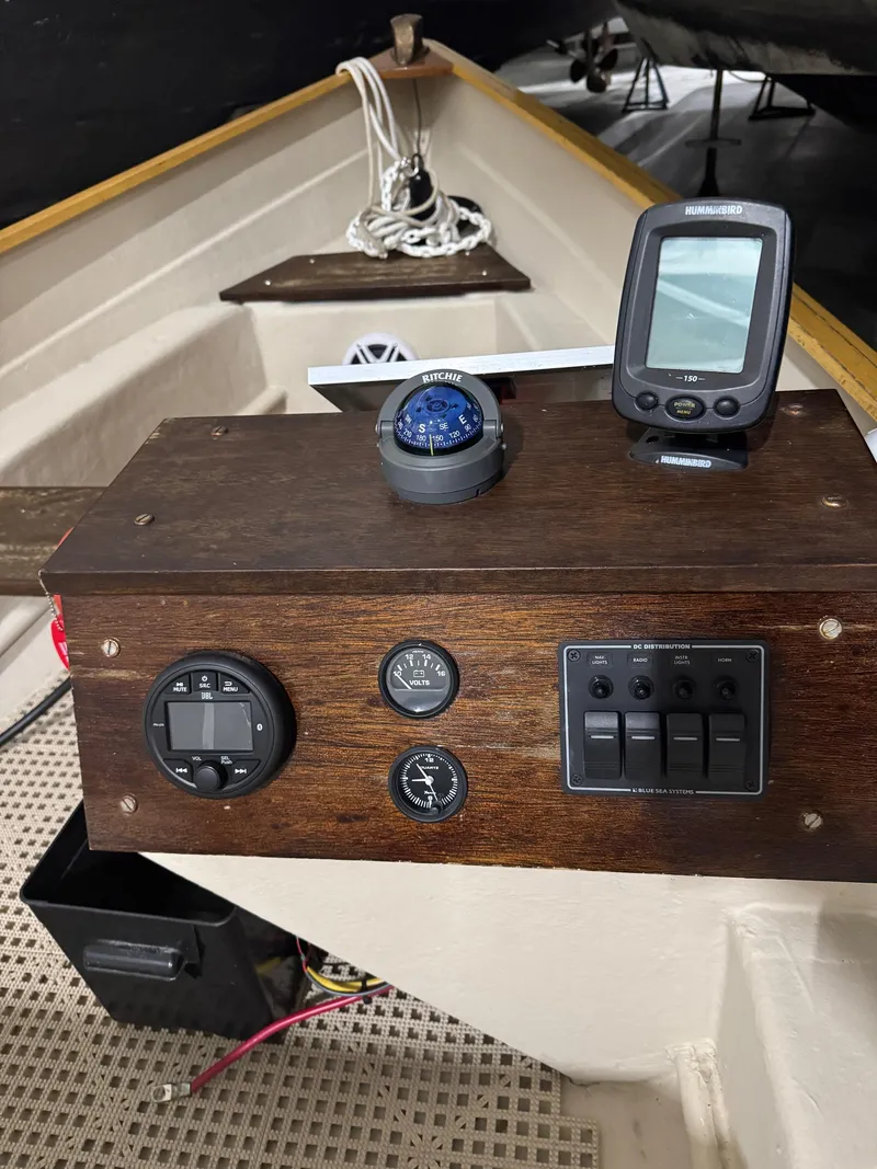 Slide: The Image of 1988 Stur-Dee Amesbury Dory boat dashboard with compass and electronic display. - 11