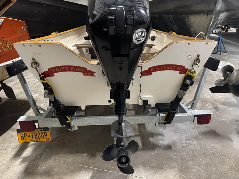 Slide: The Image of 1988 Stur-Dee Amesbury Dory 14' boat on trailer with outboard motor. - 2