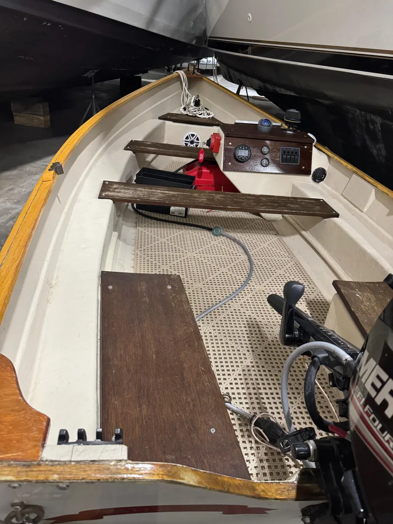 Slide: The Image of 1988 Stur-Dee Amesbury Dory 14' boat interior with wooden seats and control panel. - 6