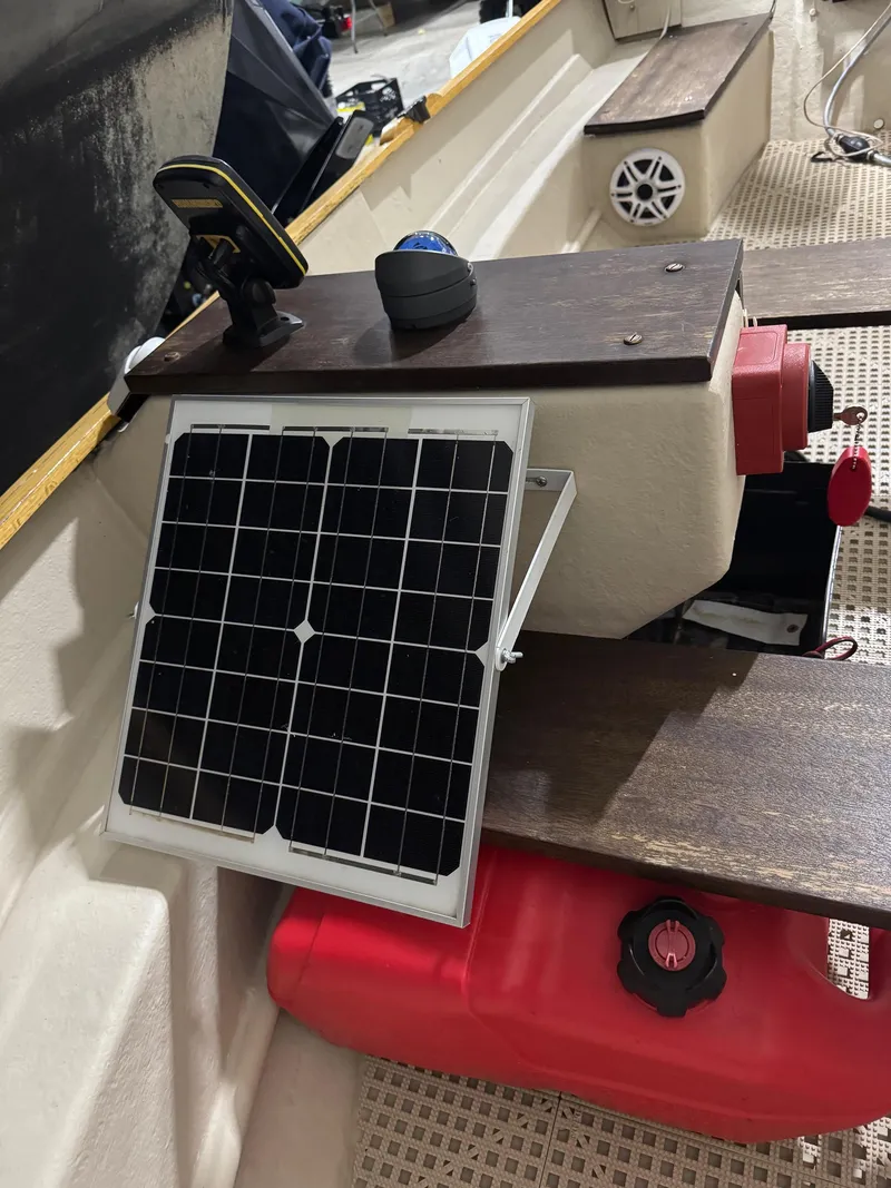 Slide: The Image of 1988 Stur-Dee Amesbury Dory boat interior with solar panel and red fuel tank. - 8