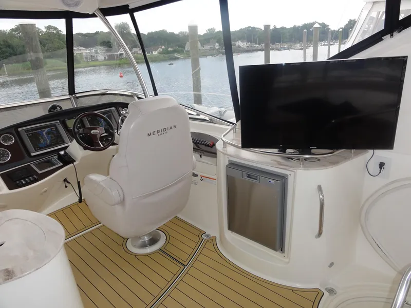 Slide: The Image of Interior of 2009 Meridian 441 Sedan yacht with helm, seating, and TV. - 11