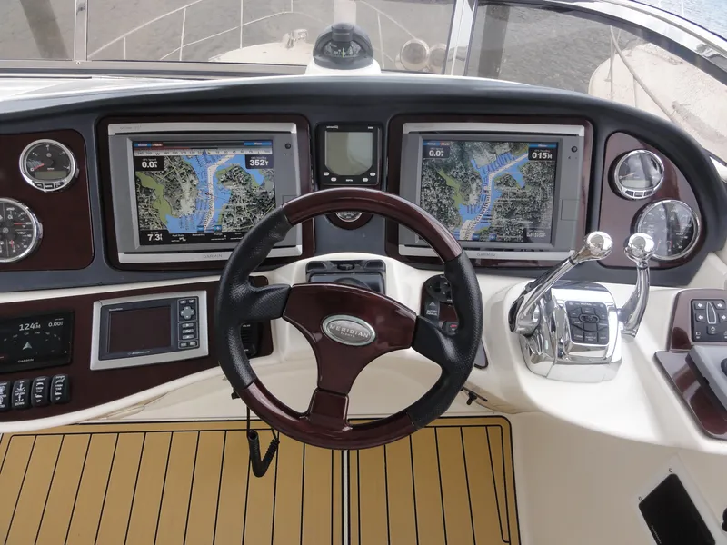 Slide: The Image of 2009 Meridian 441 Sedan helm with dual navigation screens and polished controls. - 14