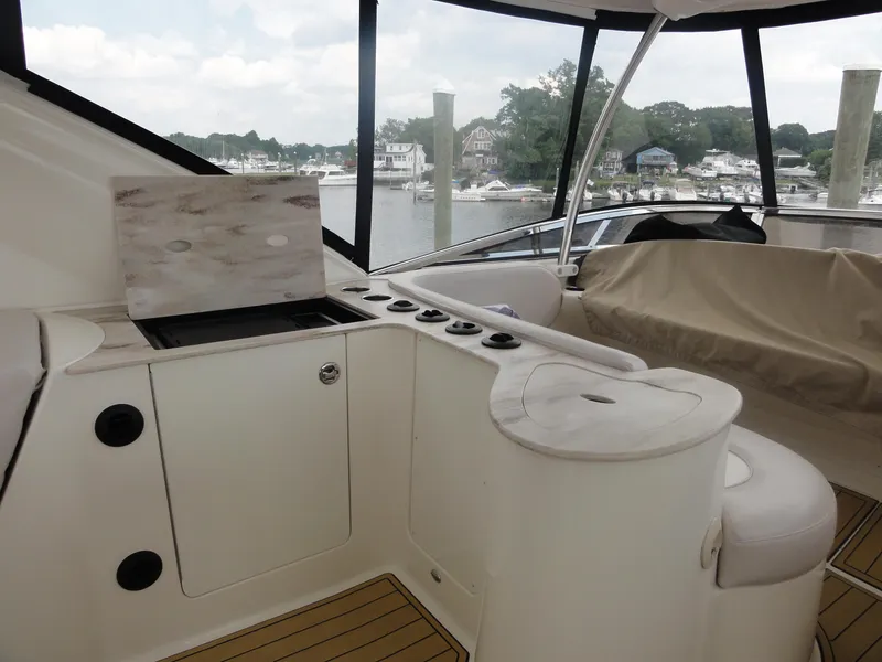 Slide: The Image of 2009 Meridian 441 Sedan yacht interior with seating and kitchenette, overlooking marina. - 15